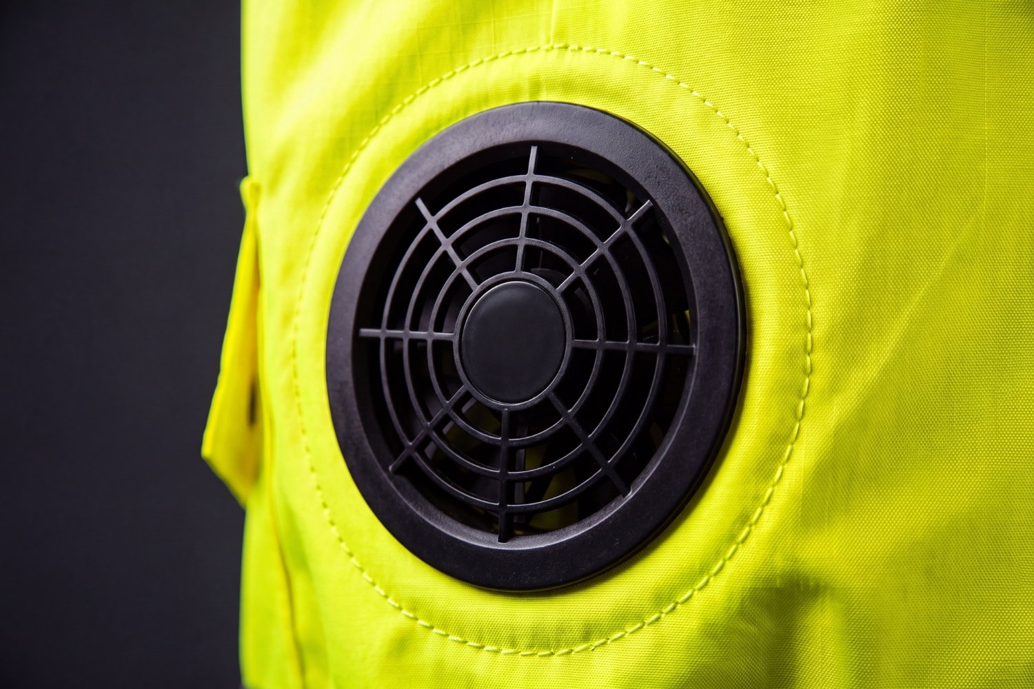 Close-up of the brushless fan module set into the side panel of the hi-vis vest