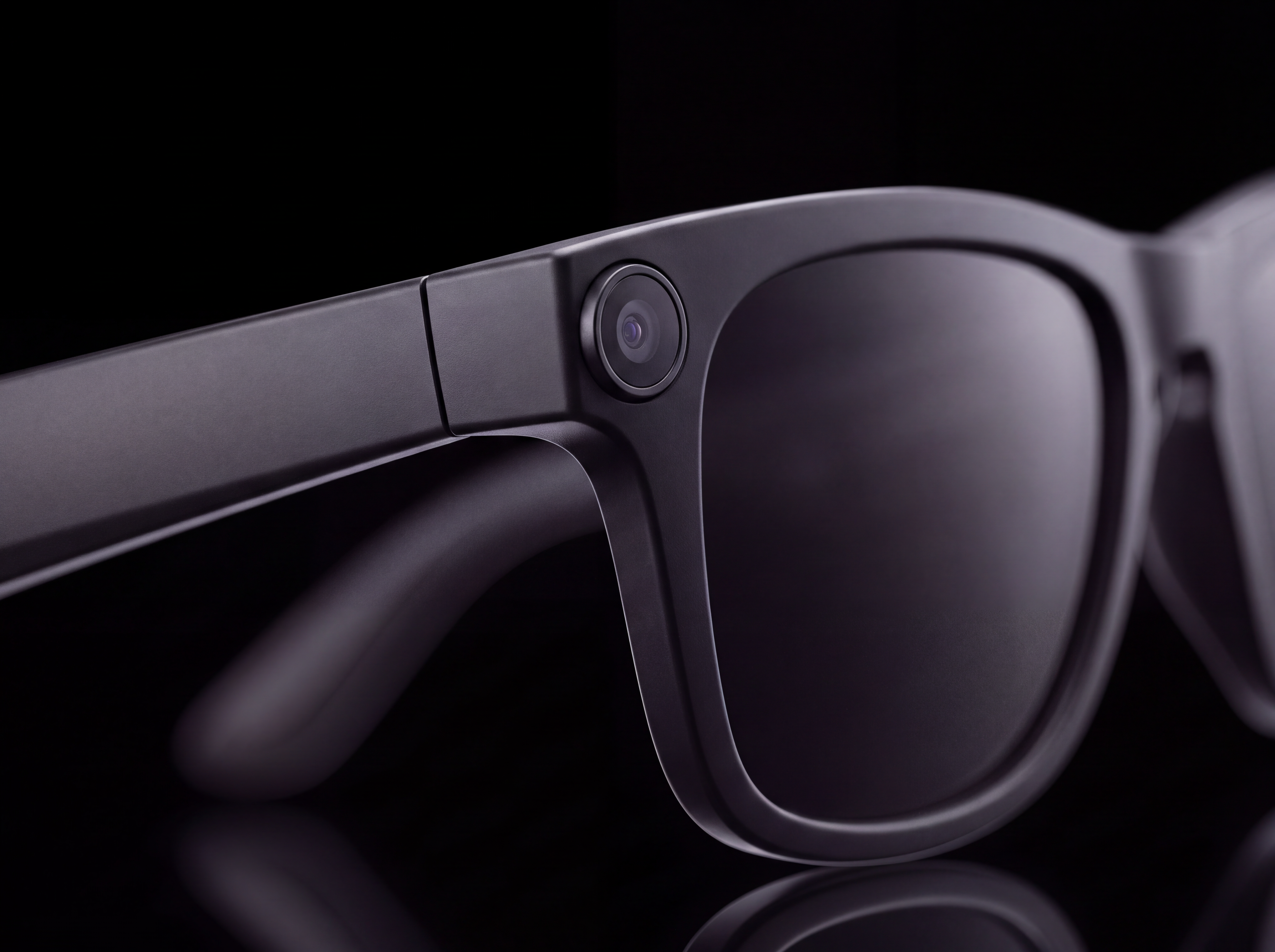 Extreme close-up of the camera module at the corner of the NEXVO One frame, catching a cool specular reflection
