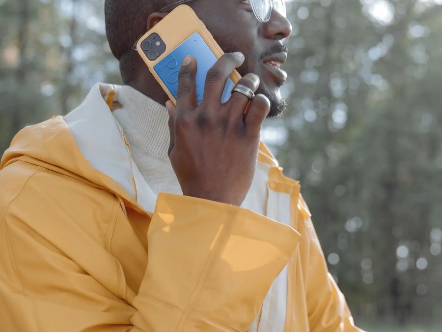 A man on a phone call with Pocket on the back of his phone