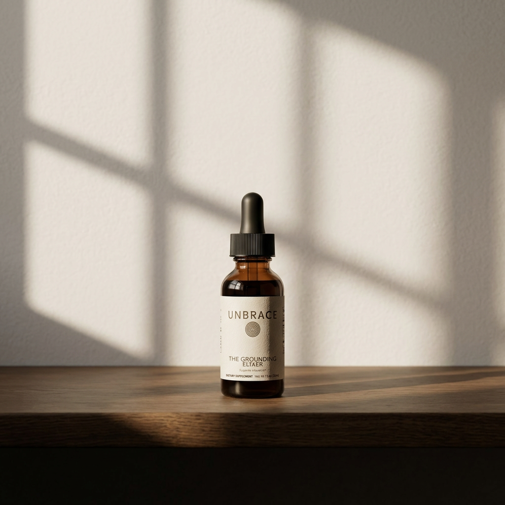 The Grounding Elixer amber glass dropper bottle in soft daylight