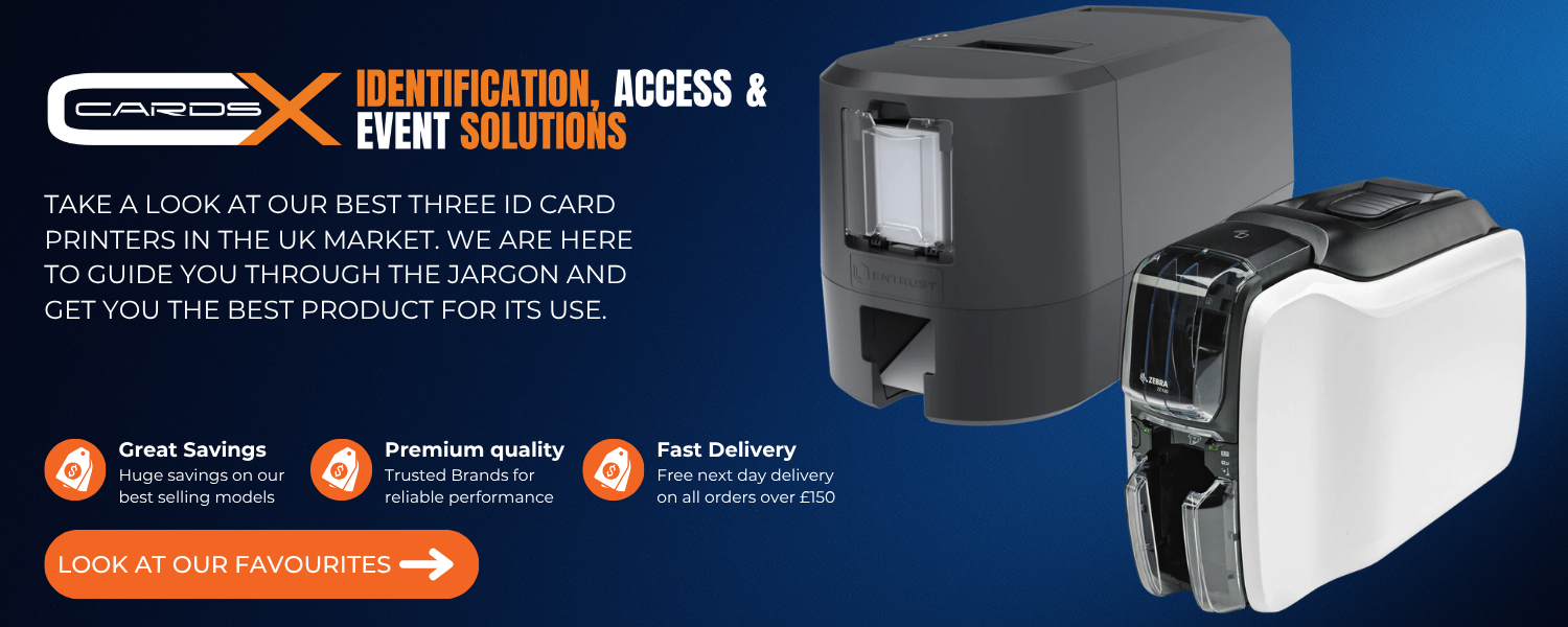 Freshly printed PVC ID badges and lanyards next to a desktop card printer