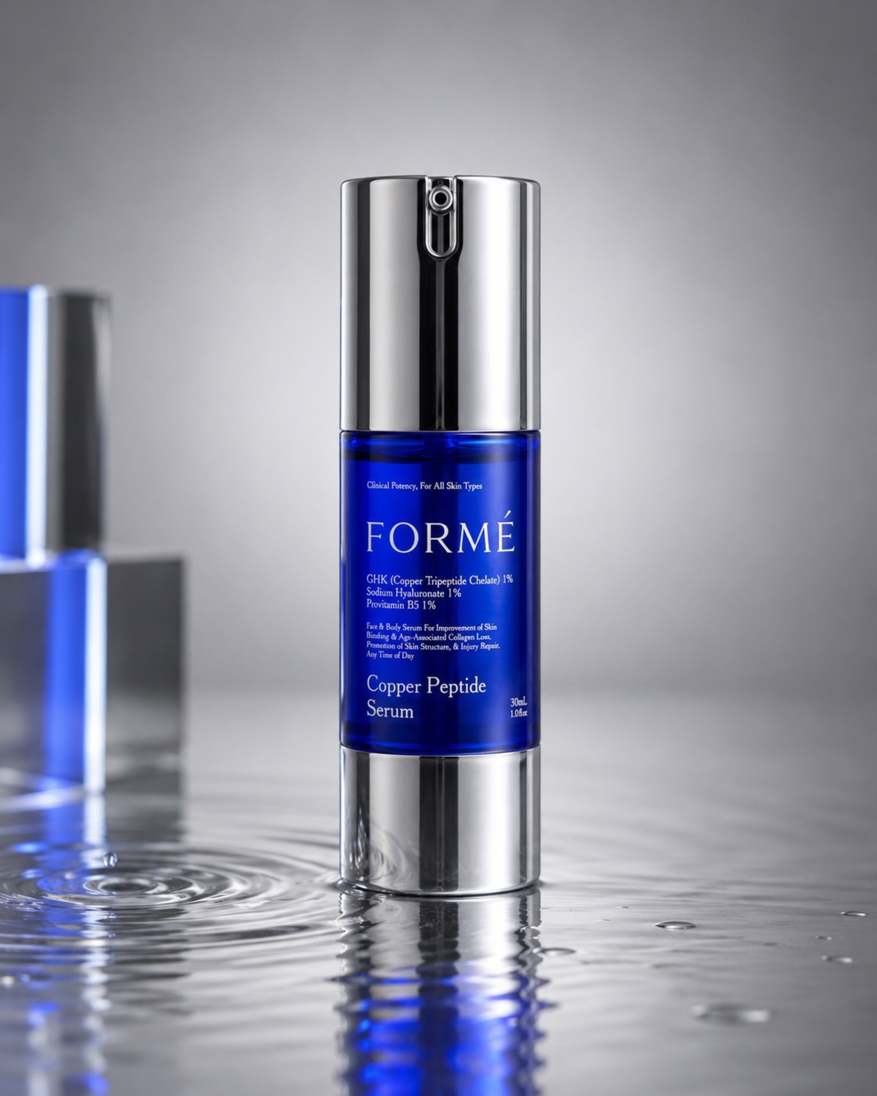 FORMÉ cobalt blue serum bottle with water droplets and chrome reflections, luxury biotech skincare image