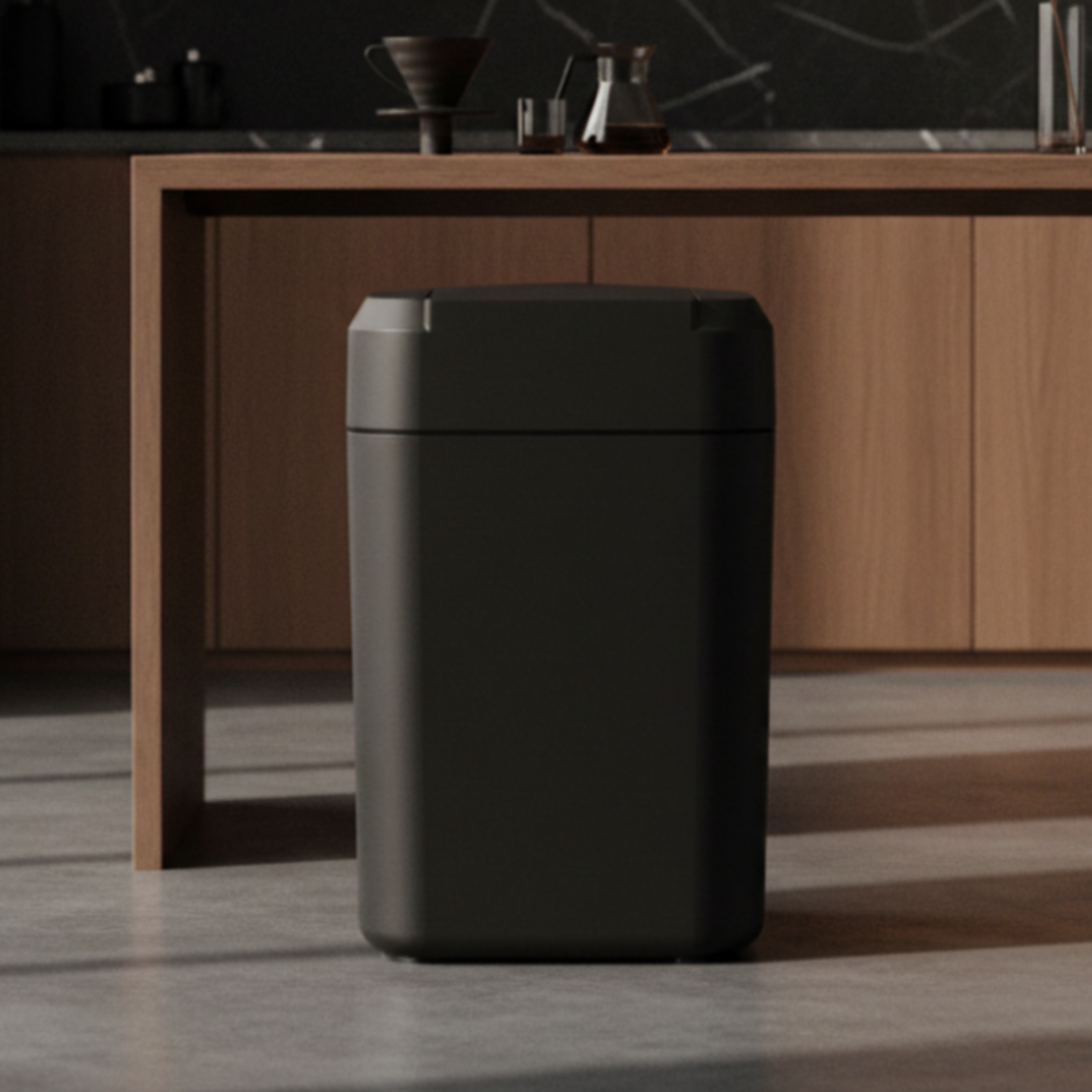 Black smart trash can in a bright modern kitchen