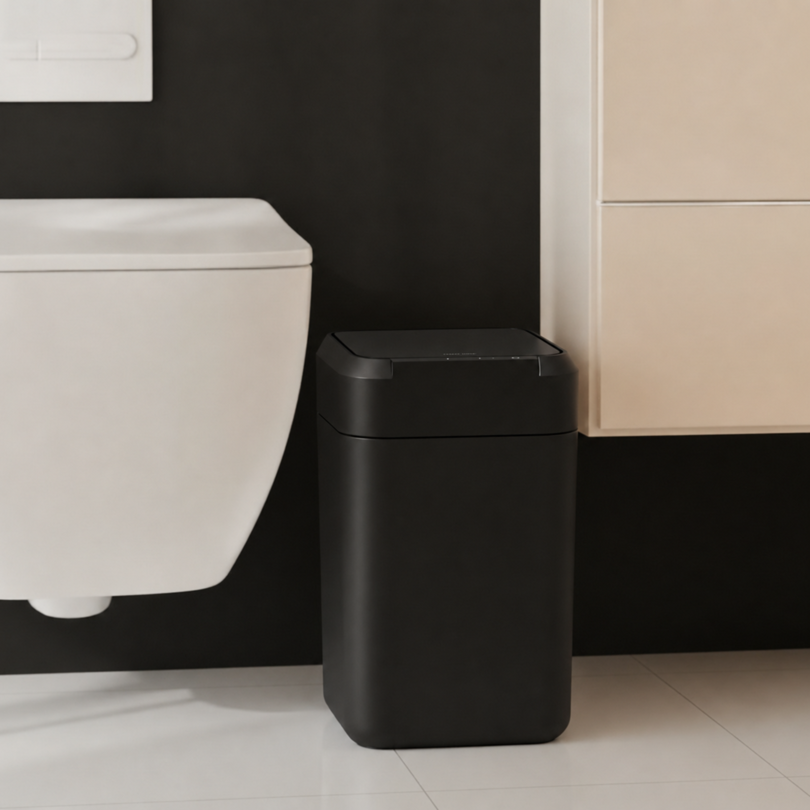 Black smart trash can beside a bathroom vanity