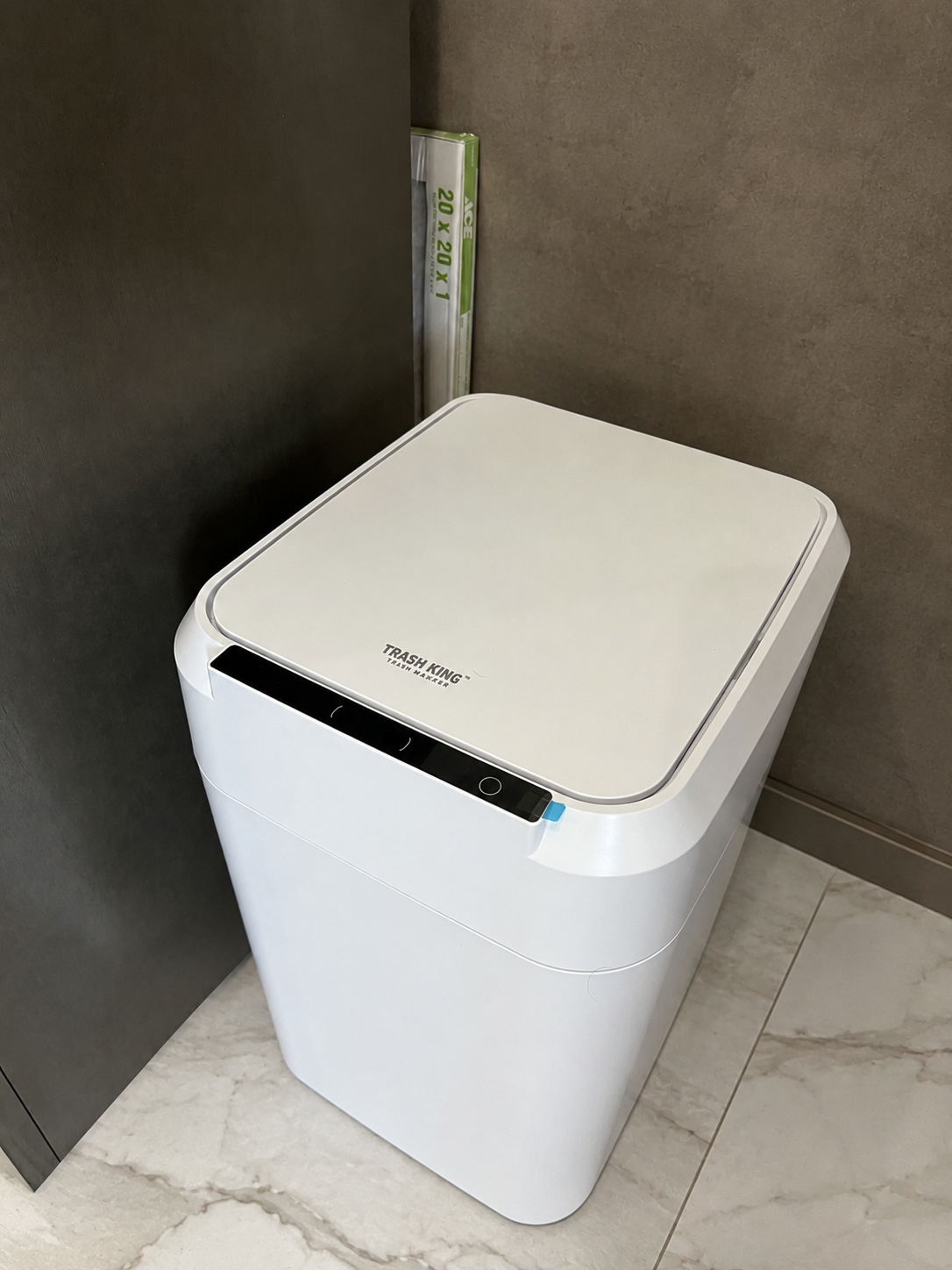 Woman tapping the lid of her smart trash can