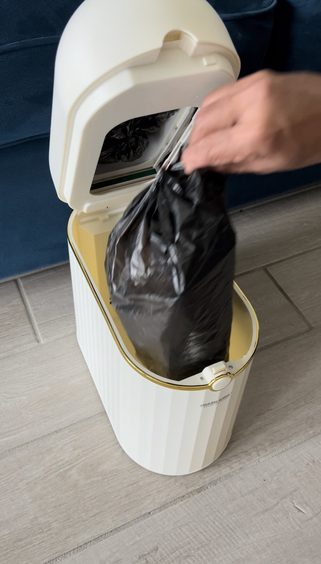 Hand lifting a sealed bag out of the Crown 10L