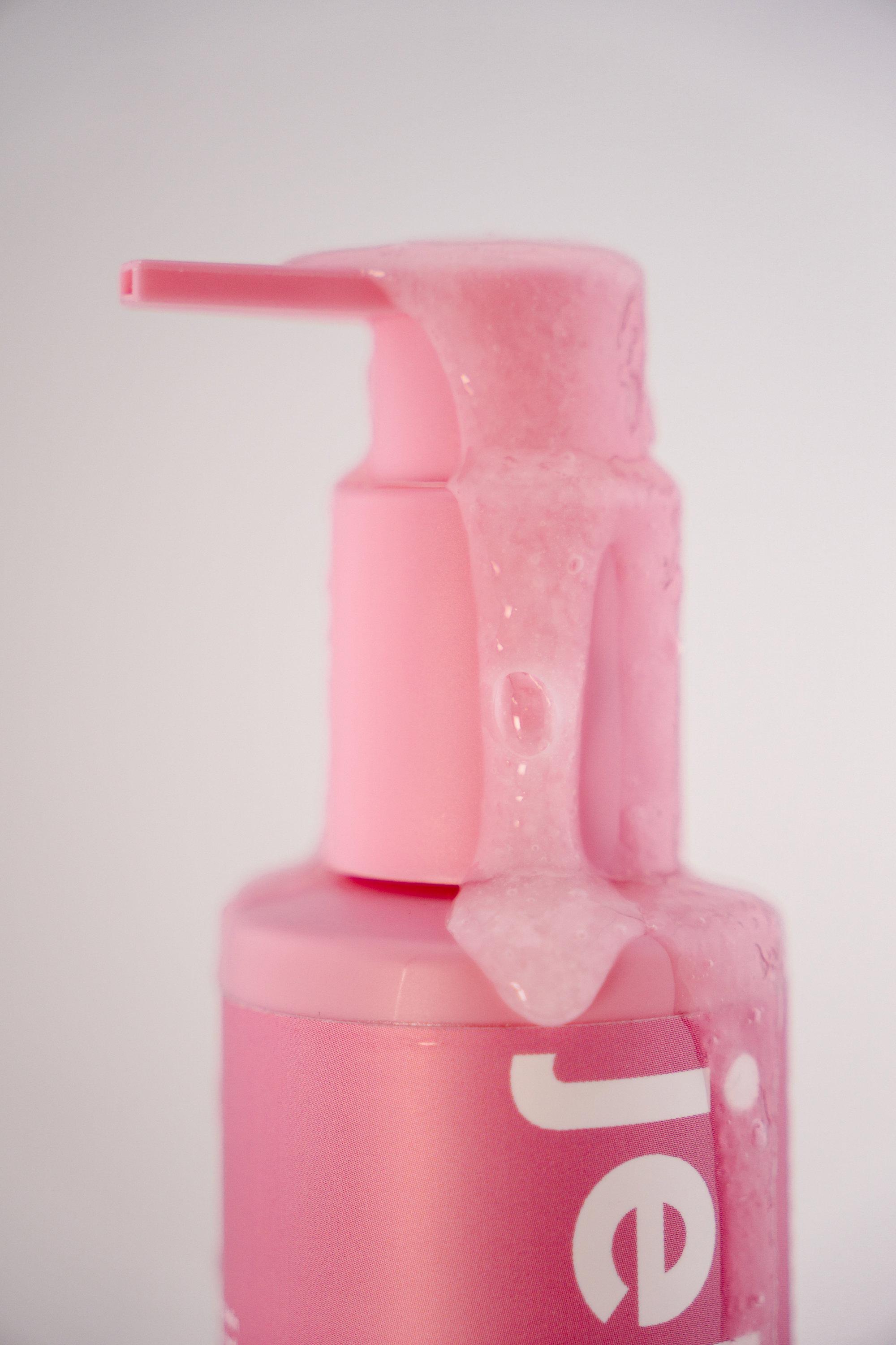 Lemon Jelly cleanser bottle surrounded by citrus slices and gel swatches on pink