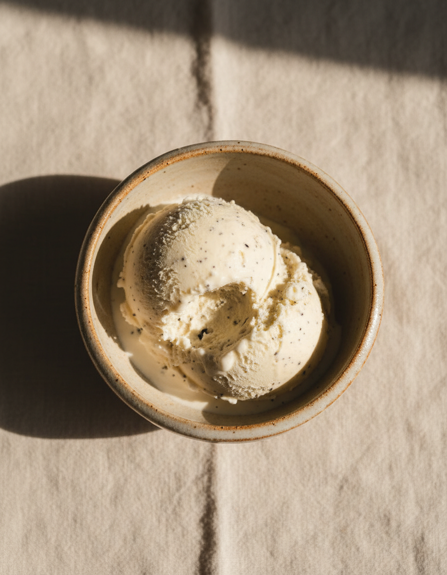 Bowl of hand-churned vanilla bean ice cream flecked with black seeds