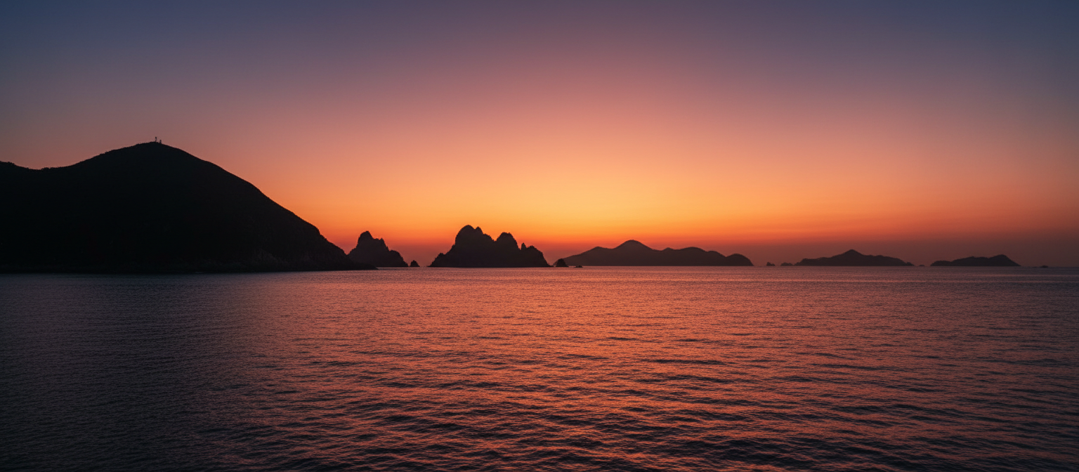 Sunset over calm sea and silhouetted islands in Hong Kong's Sai Kung