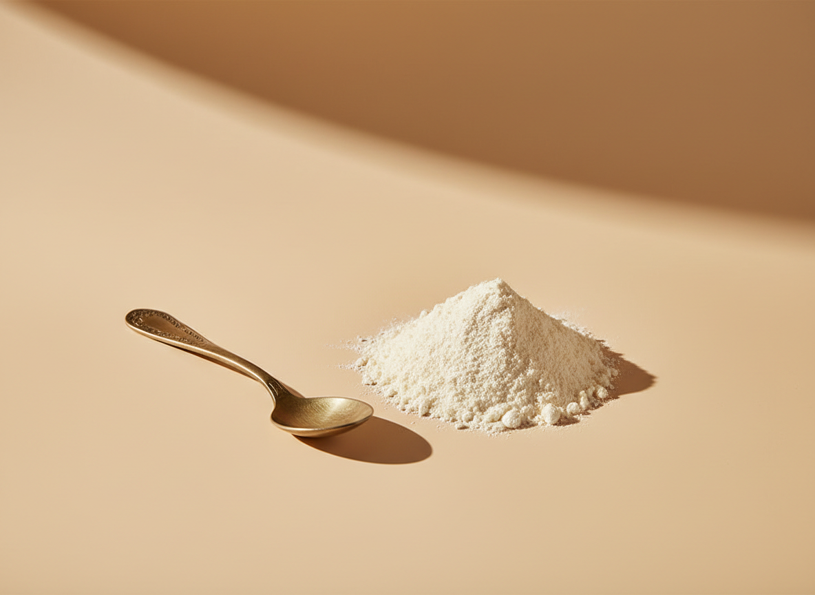 Prebiotic fiber powder beside a brass spoon