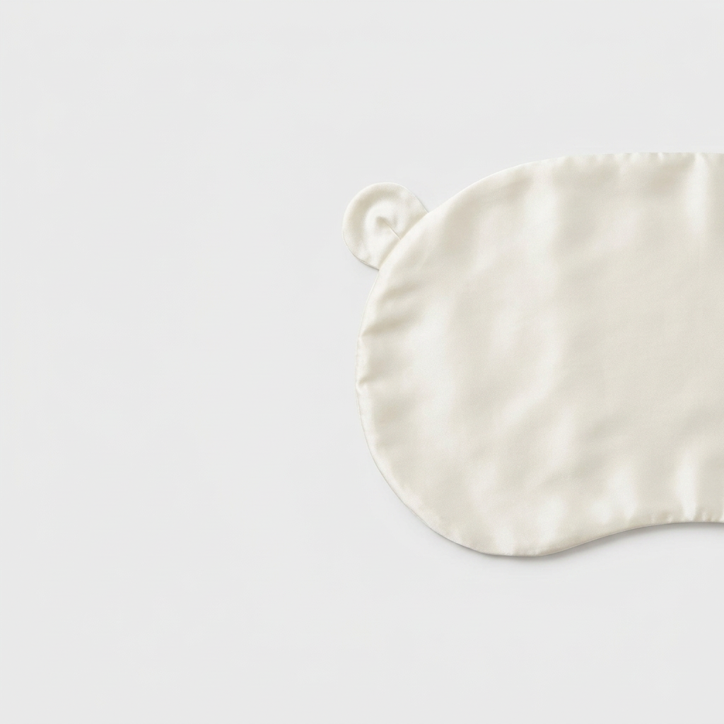 Ivory Mulberry silk head sheet with two little ears on a light grey background