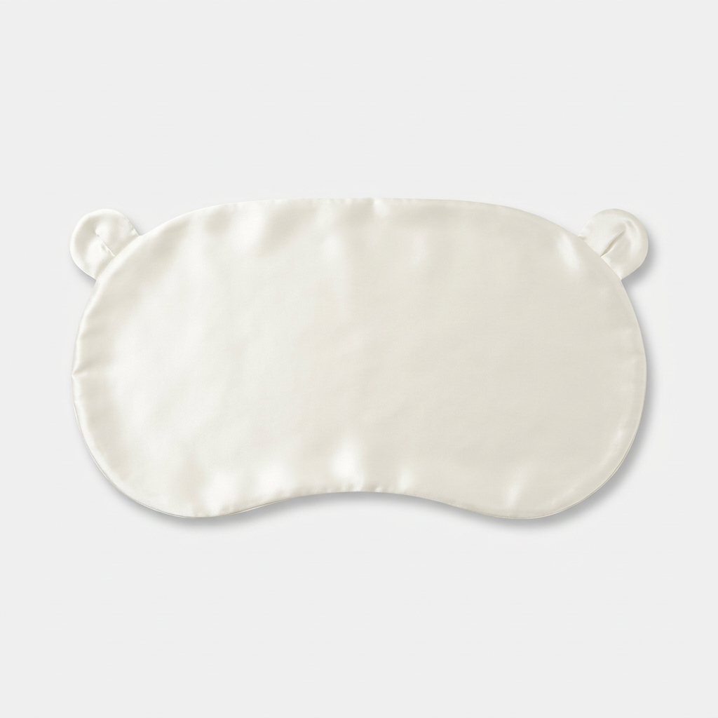Ivory Mulberry silk head sheet with two little ears, laid flat on a light grey background