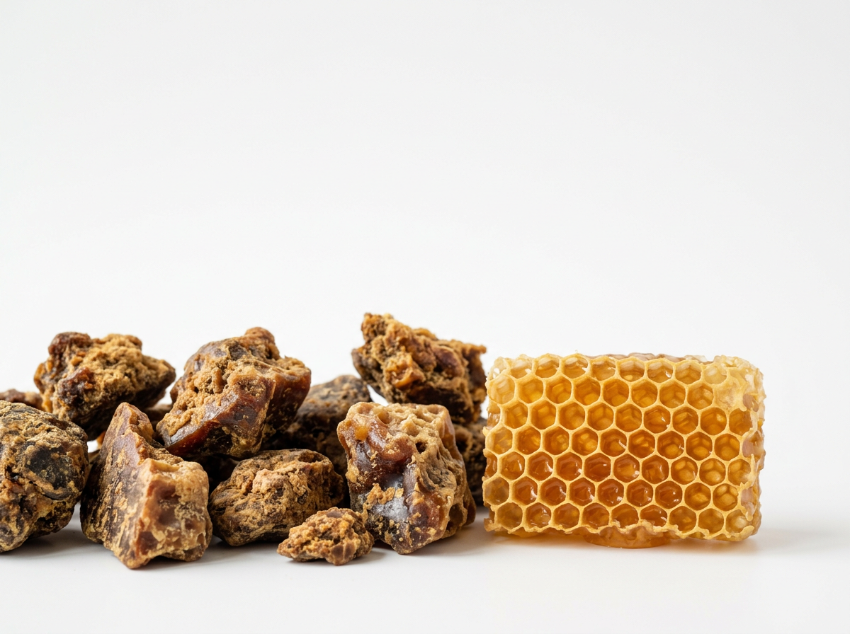 Raw bee propolis beside golden honeycomb