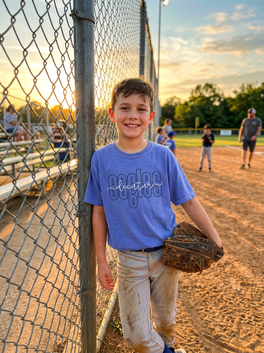 Young baseball fan with his glove at the ballfield fence