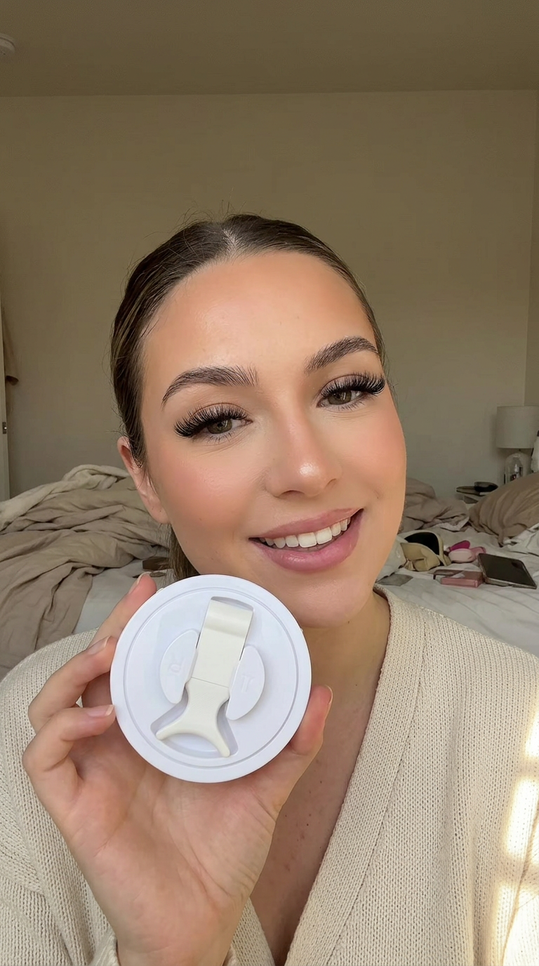 Woman holding the magnetic lash case while wearing fluffy lashes