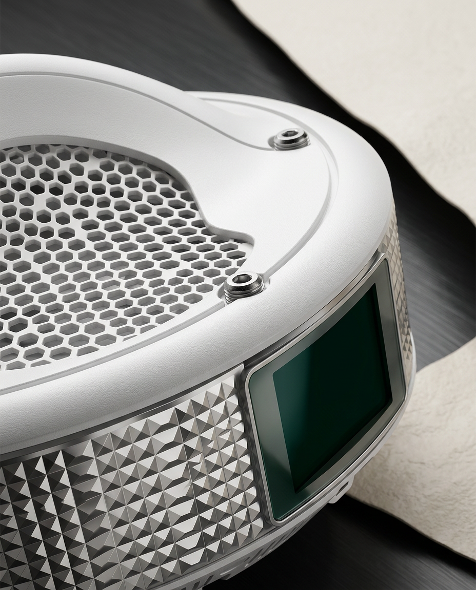 Macro detail of the faceted metallic housing and hexagonal intake grille