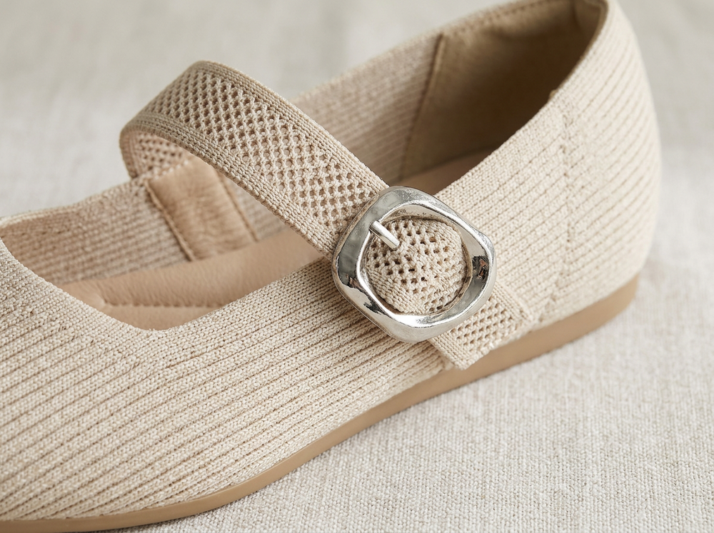 Close-up of the Soft Beige ribbed knit, breathable strap and silver buckle