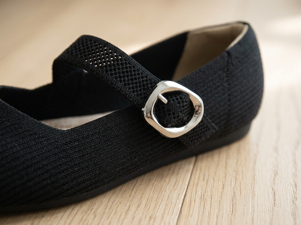 Close-up of the Classic Black ribbed knit, breathable strap and silver buckle